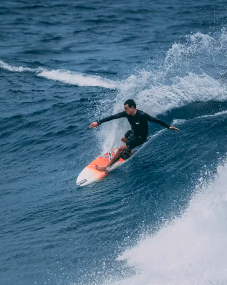 A surfer riding a wave in Bali